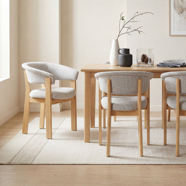 COLAMY Halo Prime upholstered dining chairs with natural solid oak frames in a bright modern dining room