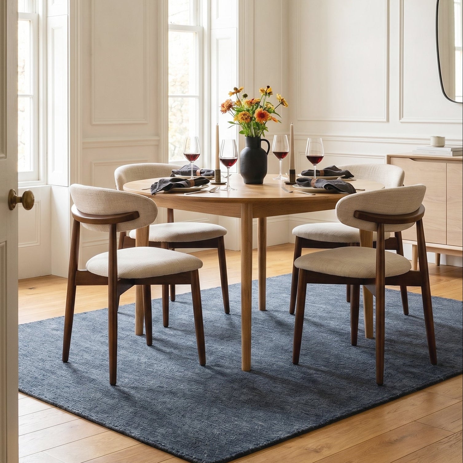 COLAMY NOYA beige fabric dining chairs around a round wooden table in an elegant dining room