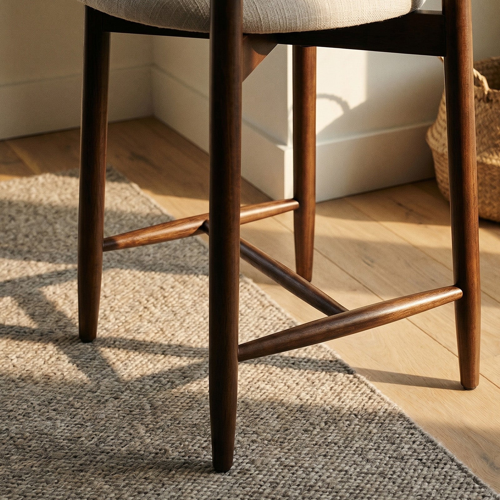 Close-up of COLAMY ARLA wooden counter stool legs with built-in footrest rail