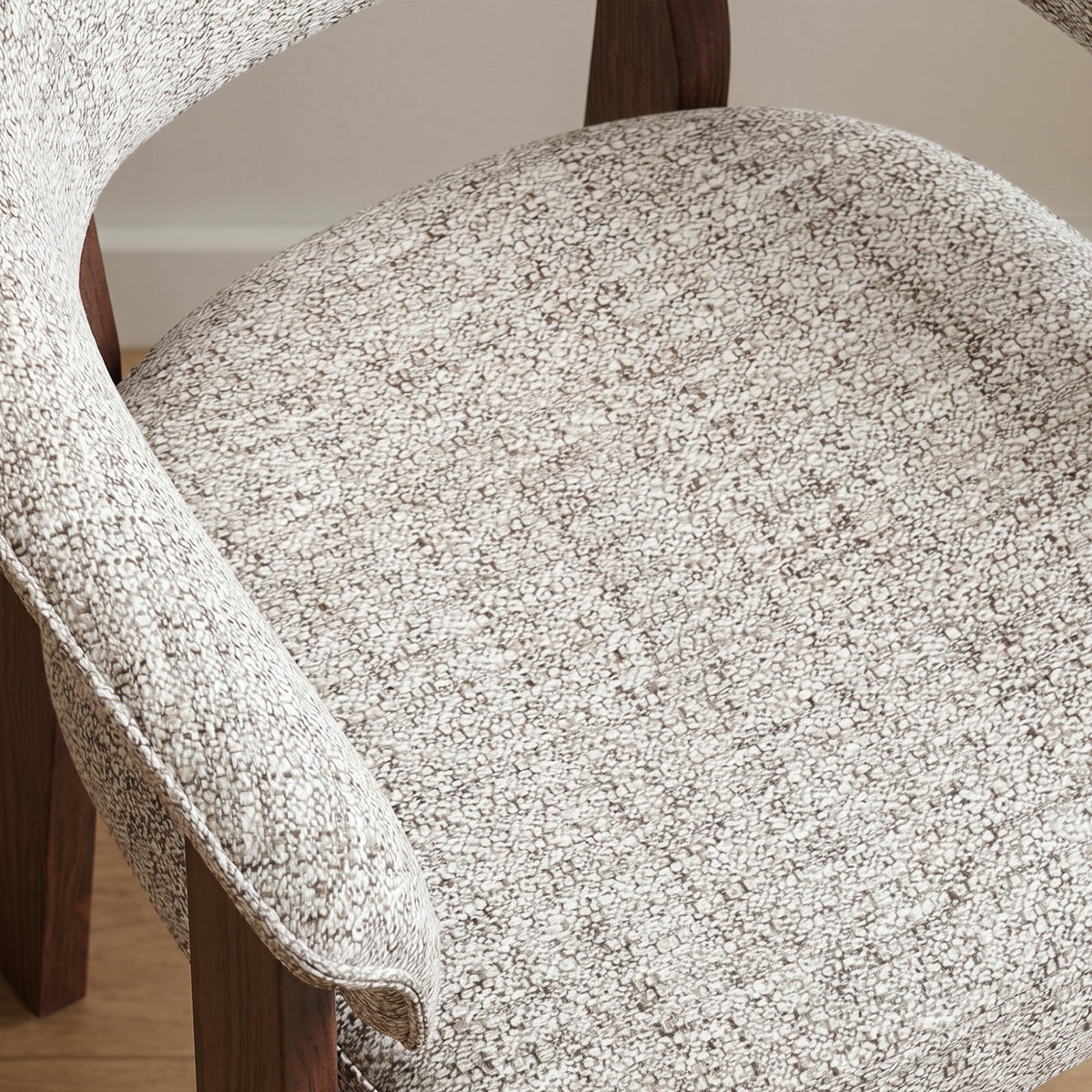 Close-up of the Halo Luxe dining chair’s textured upholstery, curved backrest and generously padded seat