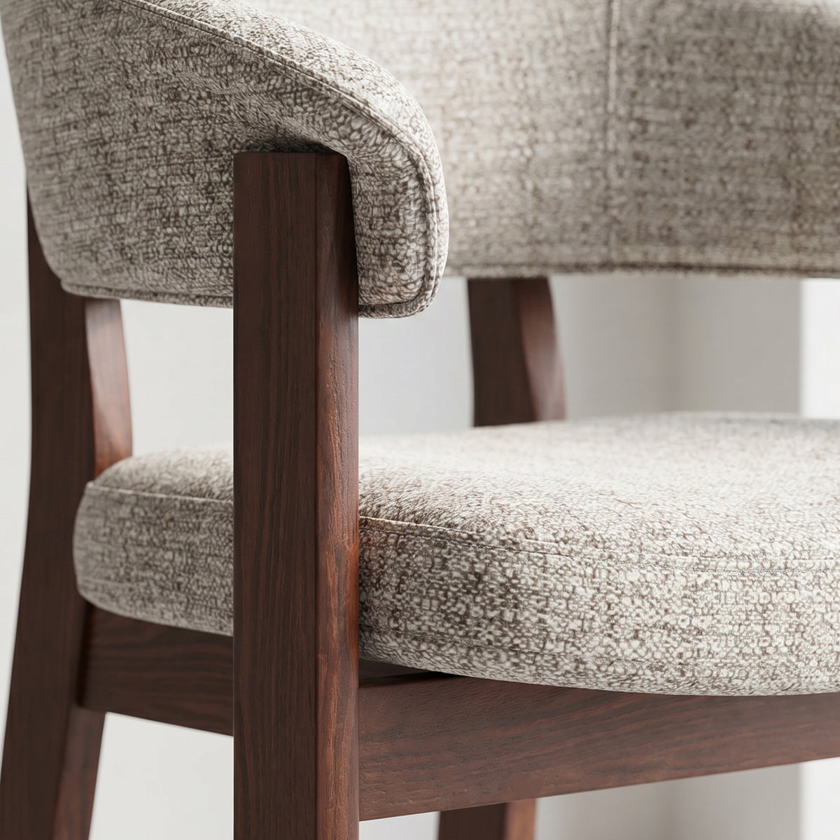 Detailed view of the Halo Luxe upholstered dining chair with a padded seat and dark solid oak frame