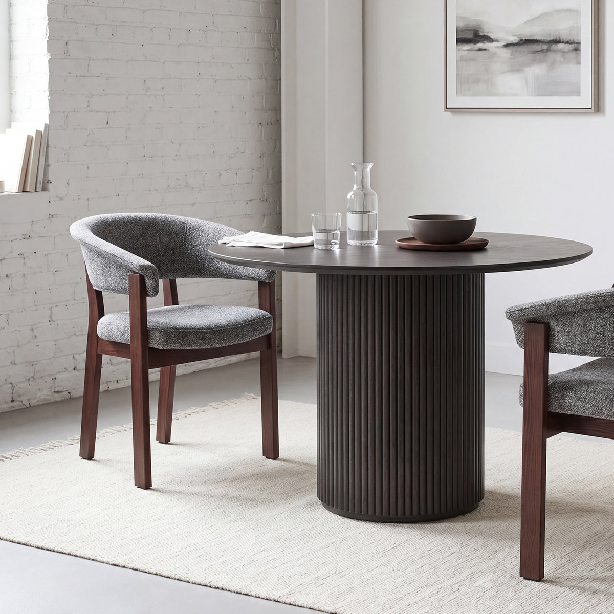 Halo Luxe upholstered dining chair with a dark solid oak frame styled beside a modern round dining table