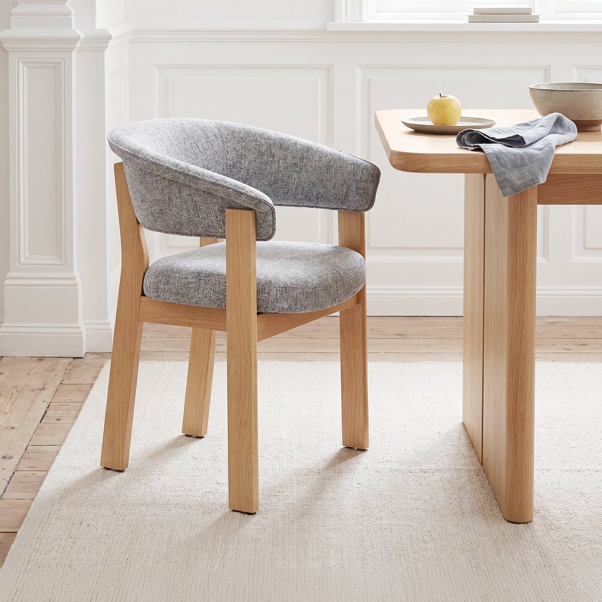 Natural solid oak Halo Luxe dining chair with a curved upholstered backrest and padded seat