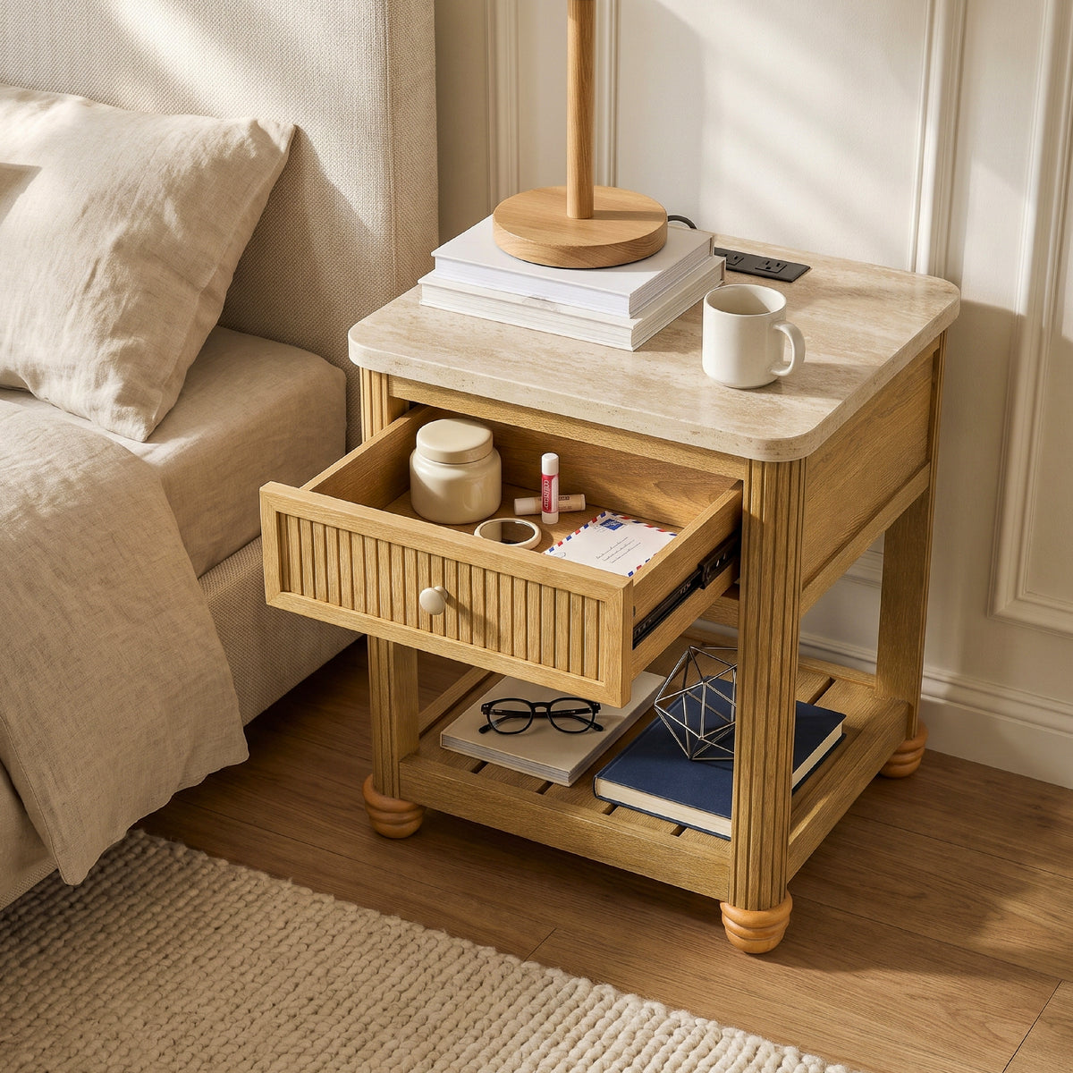 couch side table with storage drawer open holding a mug and glasses beside a beige sofa