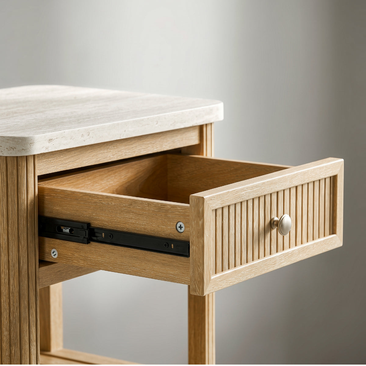 end table with drawer pulled open showing the wood drawer box and smooth metal drawer glides