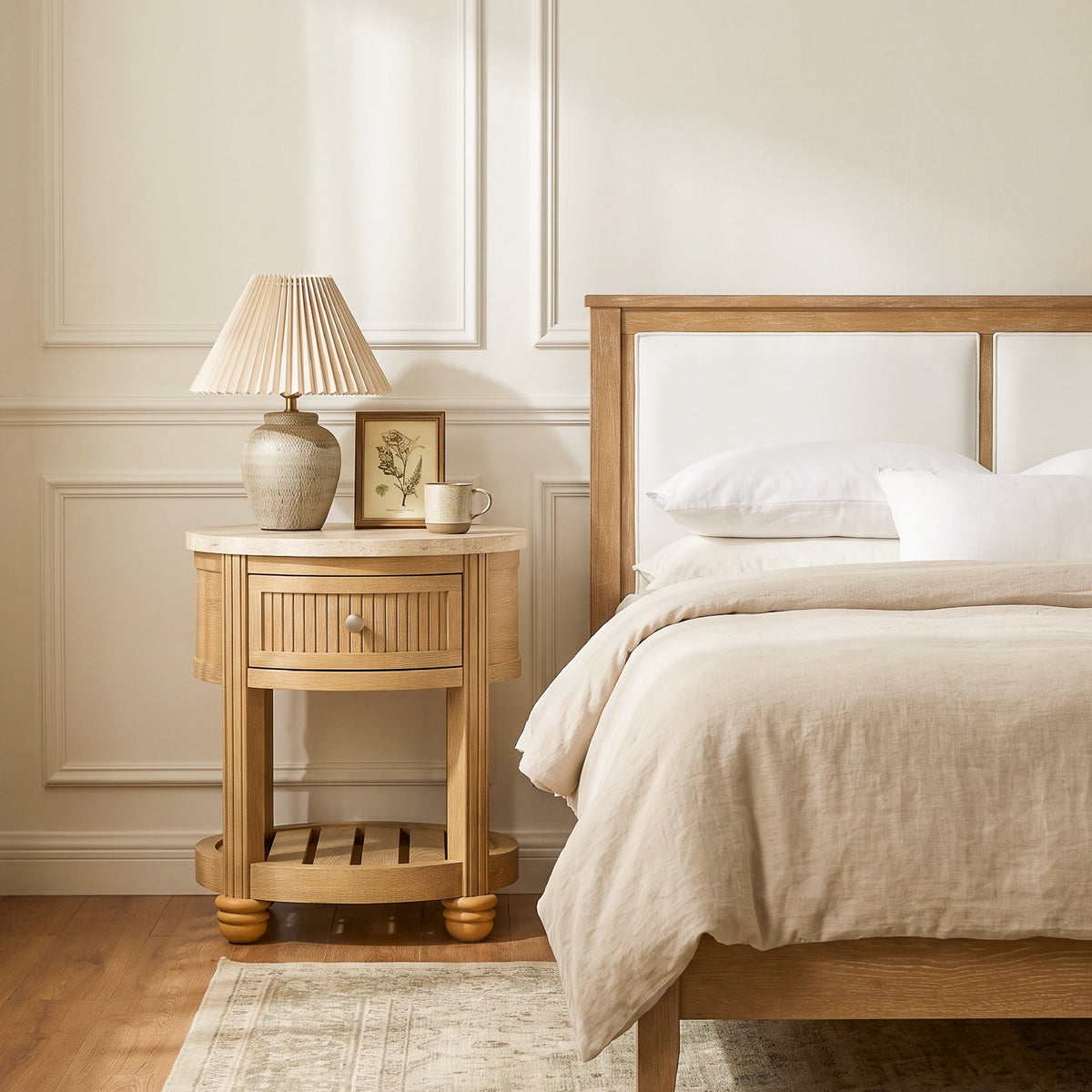 round nightstand with drawer beside bed pleated lamp