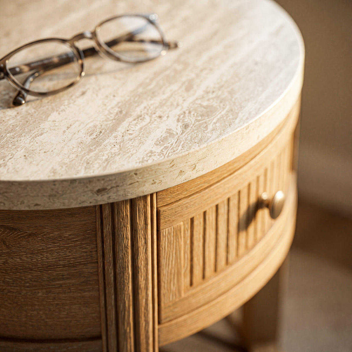 travertine inspired round side table fluted base close up